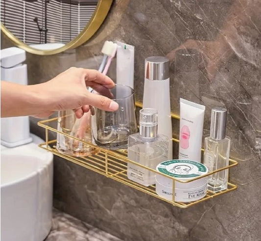 Golden wall-mounted bathroom rack with geometric design, stainless steel cosmetic organizer for makeup, skincare, and vanity storage.
