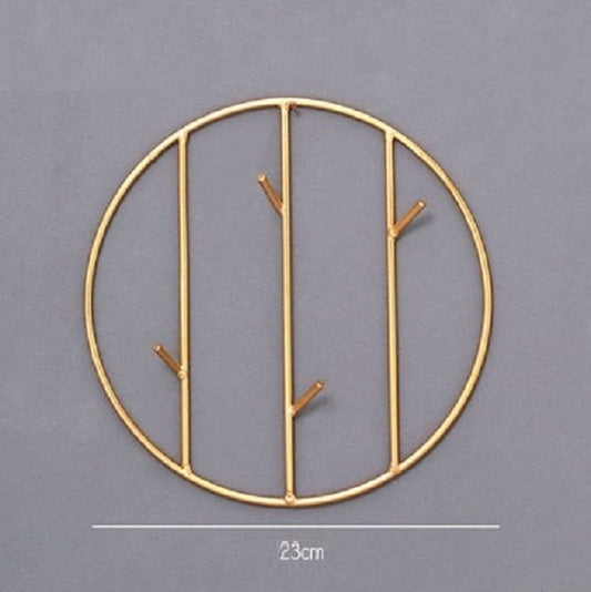Set of round and rectangular gold metal wall hooks for keys, scarves, and jewelry organization.