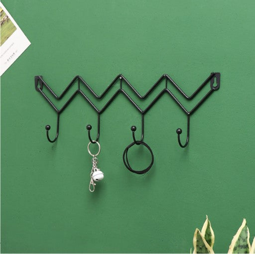 Minimalist black zig-zag wall hanging rack for entryway organization and coat storage - Decore Wholesale.