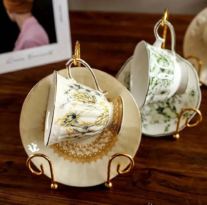 Antique gold Metal Vintage Tea Cup Display Stand holding premium porcelain cups and saucers in a glass cabinet in Pakistan decor wholesale