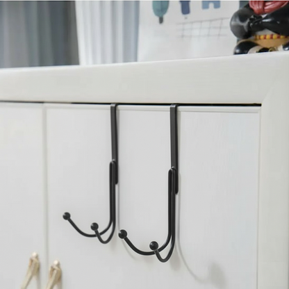 Sleek Metal Over the Door Hook Metal Double Head Hanger holding a backpack and a winter coat behind a bedroom door in Pakistan decore whole sale