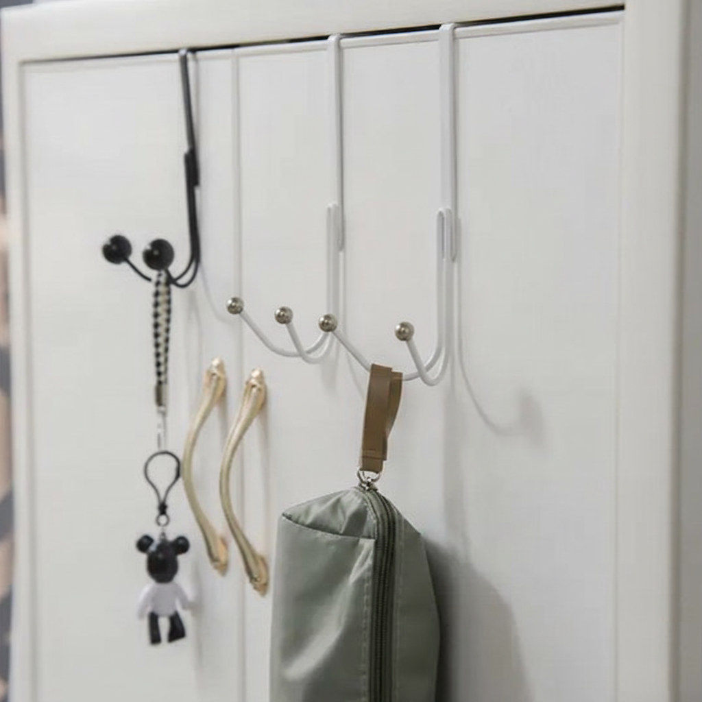 Sleek Metal Over the Door Hook Metal Double Head Hanger holding a backpack and a winter coat behind a bedroom door in Pakistan decore whole sale