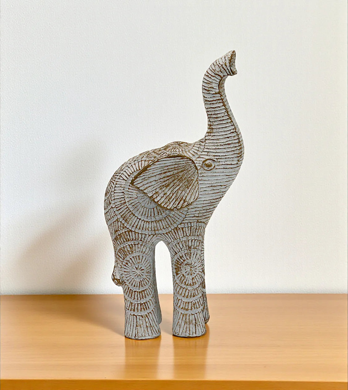 statue elephant sun up white china 7x3.6 Price in Pakistan displayed over an elegant glass table