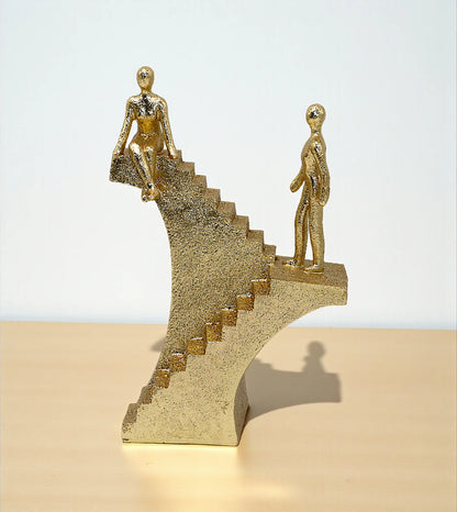imported statue climbing stair and sit on stairs golden 9.6x6.5 Price in Pakistan placed over a drawing room centerpiece table