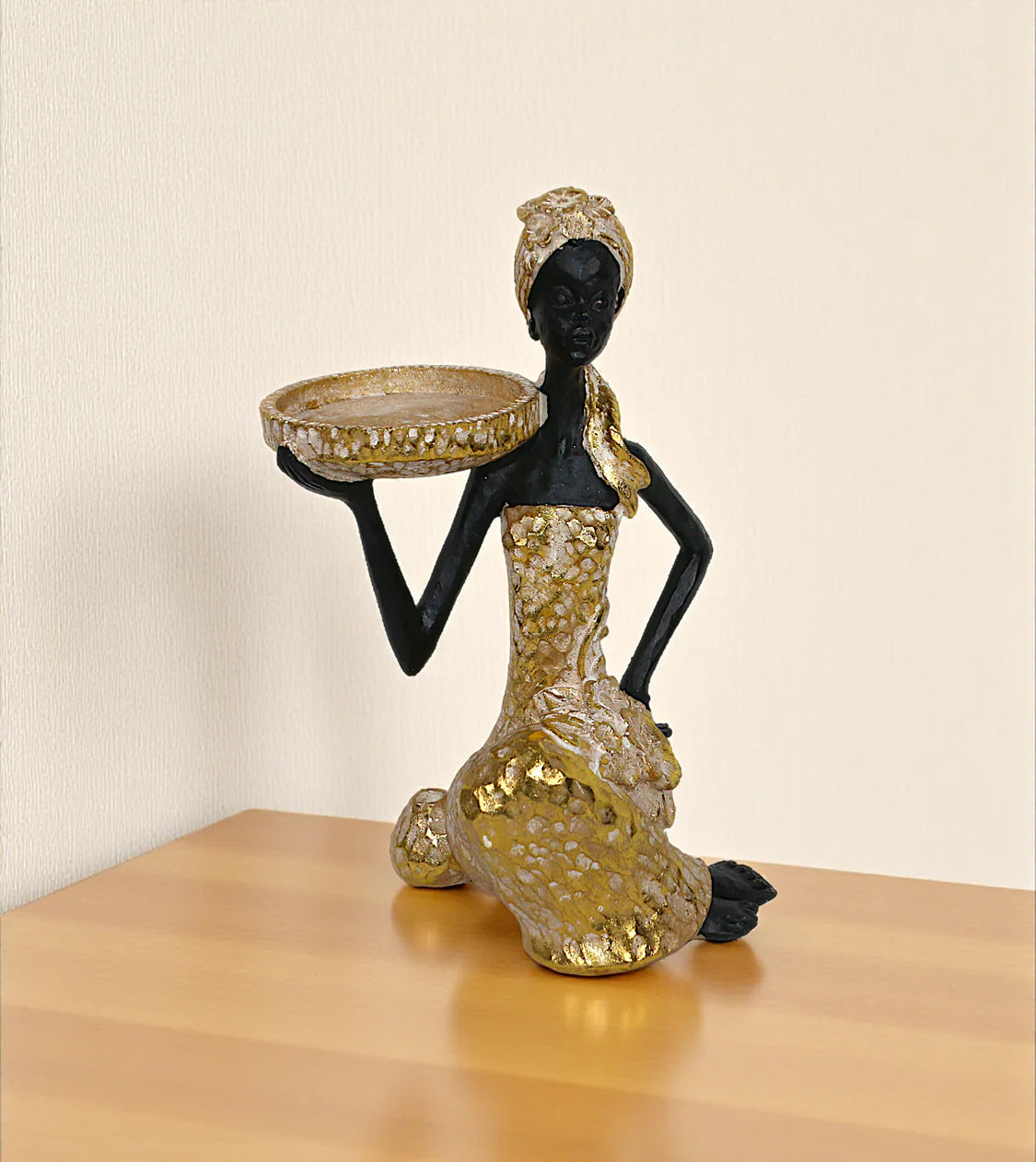 statue african lady holding stand golden large china 9.5x5.8 Price in Pakistan displayed on a bedroom vanity table