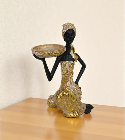 statue african lady holding stand golden large china 9.5x5.8 Price in Pakistan displayed on a bedroom vanity table