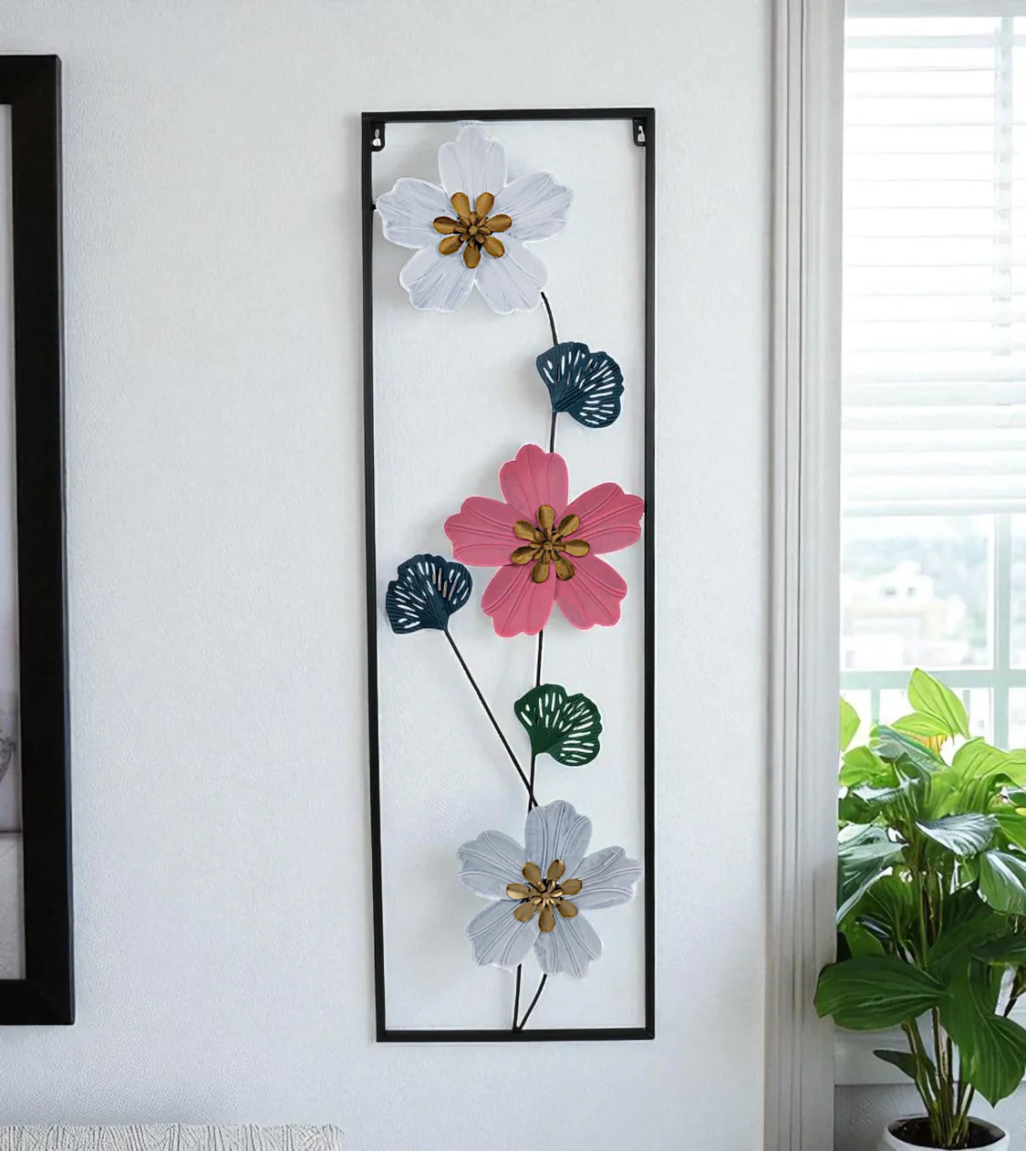 Modern Metal Wall Hanging Floral Rectangle Black imported from China mounted on an off-white living room wall in Pakistan