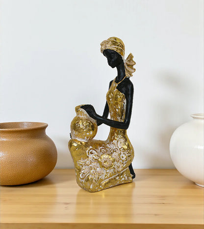 High-Volume SEO Keywords:

African lady decoration piece

Golden African woman statue

Luxury table decor items Pakistan

African figurine with mudpot

White and golden decorative statues

Living room console centerpieces

Tribal women sculptures online

Imported China home decor items

Premium room decoration ornaments

Modern ethnic home accessories
Buy African lady carrying mudpot statue online

Elegant golden African woman figurine for console table

Modern abstract African tribal sculpture with price

