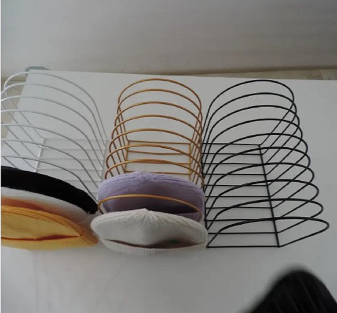 Freestanding Iron Organizer metal wire rack holding books and colorful winter caps on a table in Pakistan