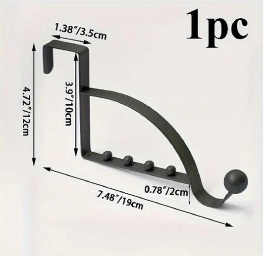 Black metal Over-the-Door Coat Rack with non-slip hooks hanging jackets and bags behind a bedroom door in Pakistan