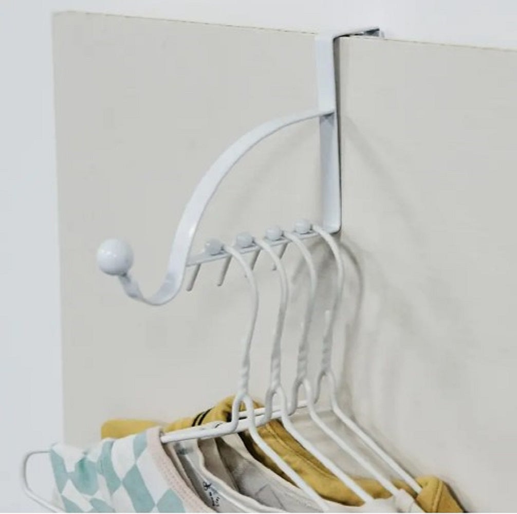 Black metal Over-the-Door Coat Rack with non-slip hooks hanging jackets and bags behind a bedroom door in Pakistan