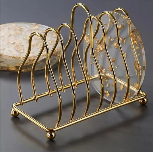 Luxury Gold Metal Plate Coaster Stand holding acrylic gold-flake coasters on a glass dining table in Pakistan