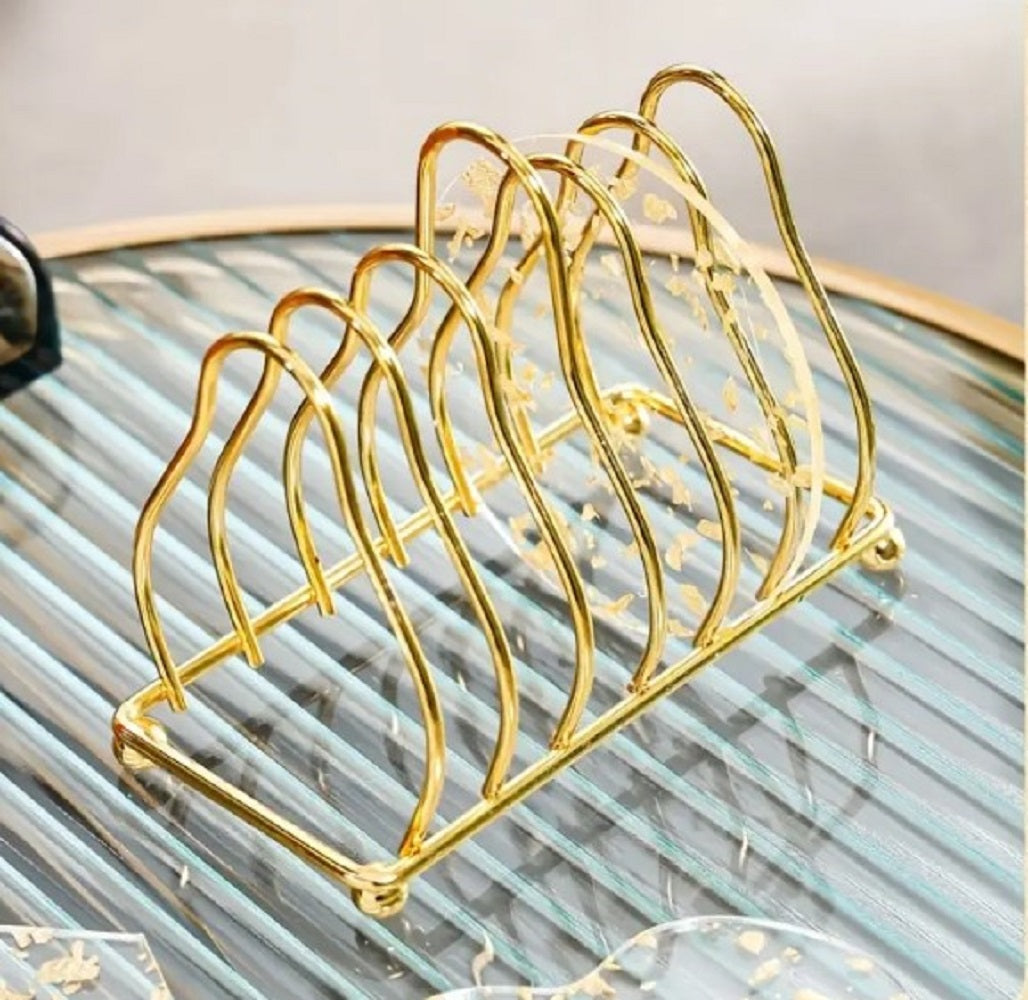 Luxury Gold Metal Plate Coaster Stand holding acrylic gold-flake coasters on a glass dining table in Pakistan