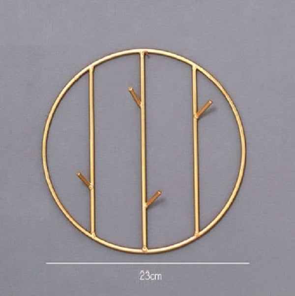 Set of round and rectangular gold metal wall hooks for keys, scarves, and jewelry organization.