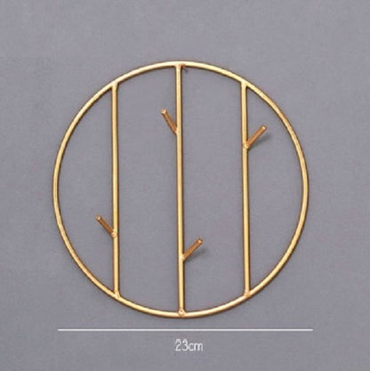 Set of round and rectangular gold metal wall hooks for keys, scarves, and jewelry organization.