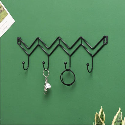 Minimalist black zig-zag wall hanging rack for entryway organization and coat storage - Decore Wholesale.