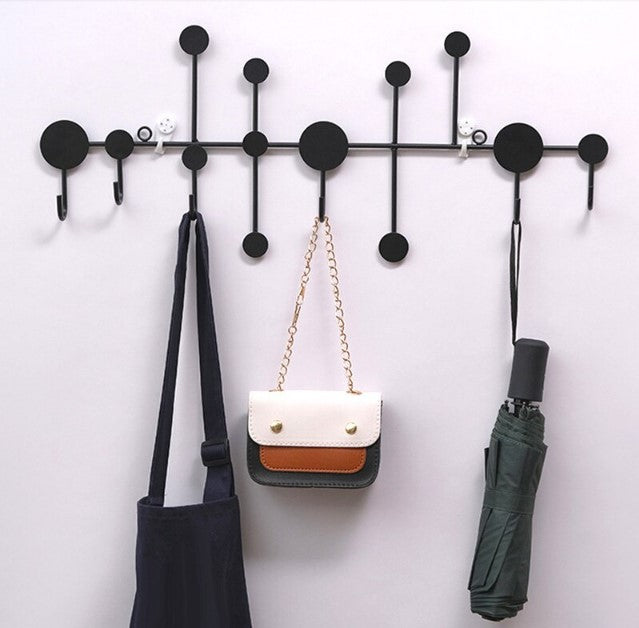 Modern black dot design wall hanging rack with handbags and scarves - Entryway and bedroom storage solution.