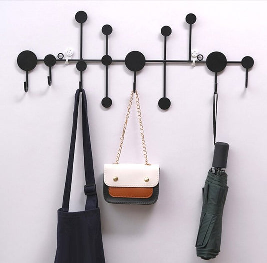 Modern black dot design wall hanging rack with handbags and scarves - Entryway and bedroom storage solution.
