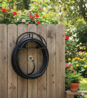 Heavy duty wall mounted Outdoor Garden Water Hose Reel holding a neatly rolled green water pipe in a lawn in Pakistan