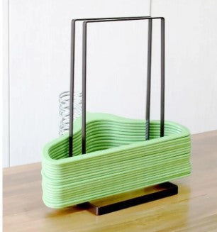 Black metal hanger organizer stand with green hangers - Compact laundry room storage solution Pakistan