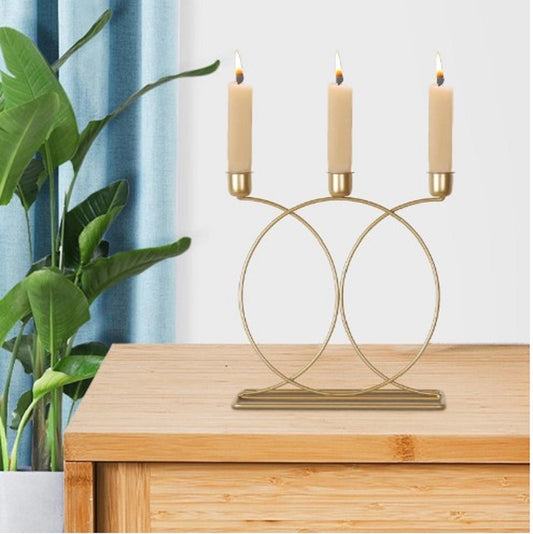 Infinity candle holder, double circle candle stand, 3 cup golden candelabra, artistic metal candle rack, geometric tabletop decor, luxury wedding candle props, modern candle holder pakistan, sasta decor wholesale, dropshipping winning products home, golden metal candlestick, candle stand for dinner date, unique shape mombatti stand, aesthetic lounge decor, premium candle display, 3 tier golden stand, candle holder shopify pakistan, wholesale home accessories, luxury centerpiece for table