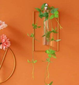 Premium heart shape gold metal wall vase with green leaves and glass tube - Luxury home decor Pakistan.