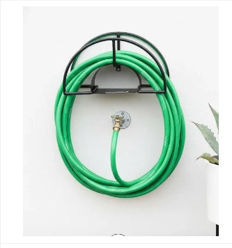 Heavy duty wall mounted Outdoor Garden Water Hose Reel holding a neatly rolled green water pipe in a lawn in Pakistan