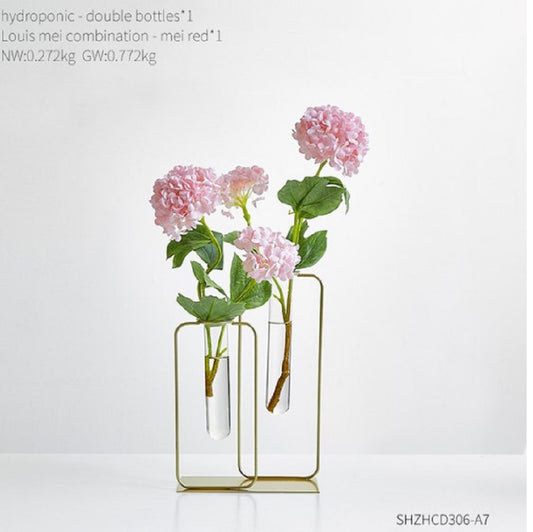 Elegant gold metal frame hydroponic vase with two glass bottles and pink flowers - Luxury home decor Pakistan
