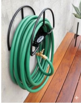 Heavy duty wall mounted Outdoor Garden Water Hose Reel holding a neatly rolled green water pipe in a lawn in Pakistan