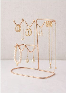 Elegant metal jewelry organizer stand displaying earrings and necklaces on a vanity table, by Decore Whole Sale.