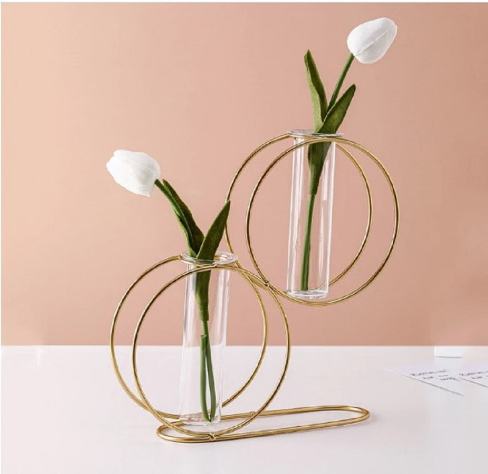 Modern V-shape gold metal wire vase for single stem flowers and minimalist office desk decoration.