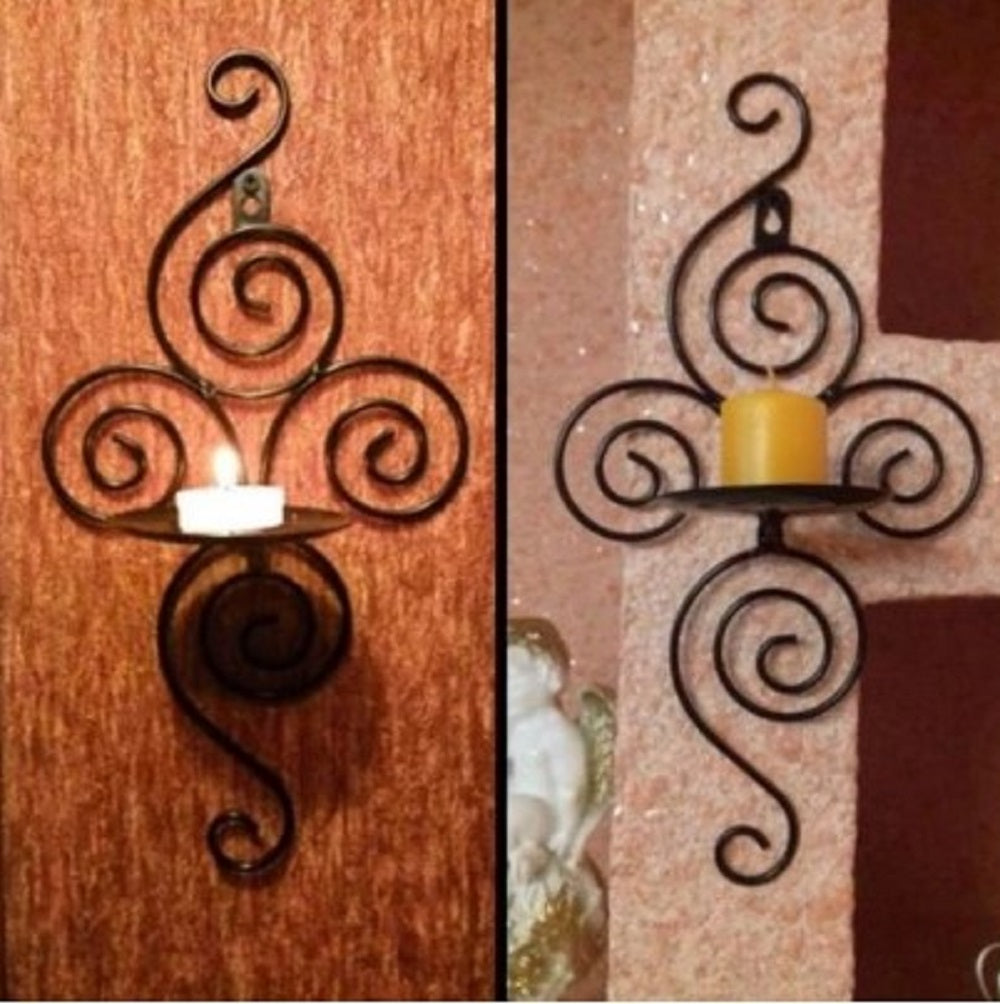 Vintage spiral wrought iron wall candle holder with white candle on wooden background - Classic home decor Pakistan