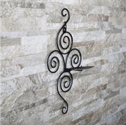 Black curly spiral metal wall sconce with yellow candle - Artistic entryway decoration and mood lighting