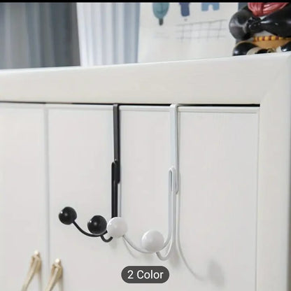 Sleek Metal Over the Door Hook Metal Double Head Hanger holding a backpack and a winter coat behind a bedroom door in Pakistan decore whole sale