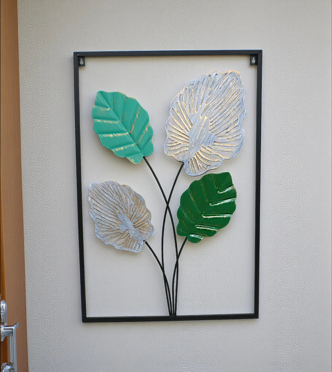 Metal Wall Hanging Floral Rectangle Black with detailed leaf art displayed on a drawing room wall in Pakistan